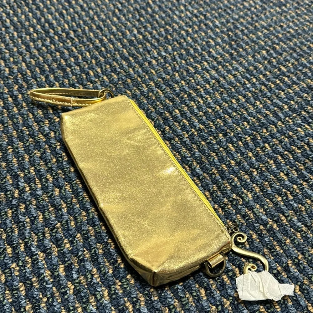 Small gold cosmetic bag w/decorative zipper pull. NWT